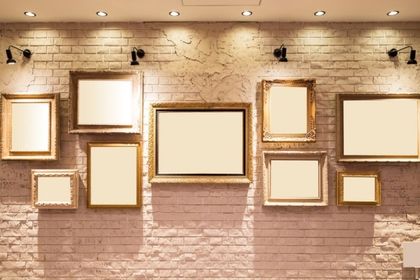 Empty frames on a wall with subtle lighting