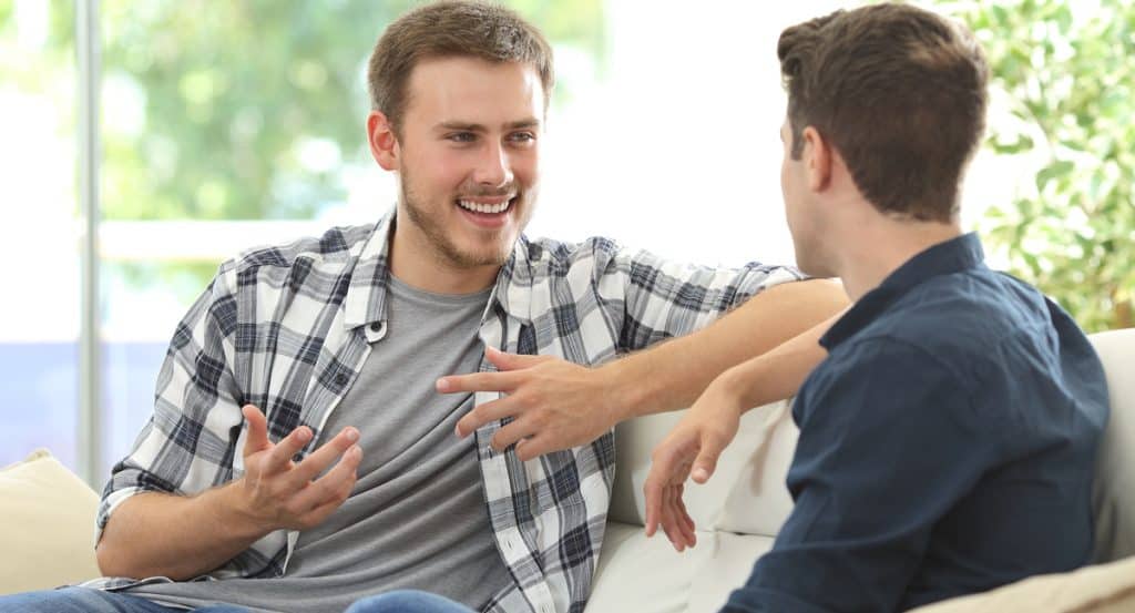 Two men in animated conversation