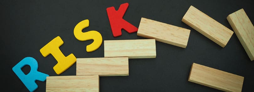 Letters and blocks of wood spelling out the word risk