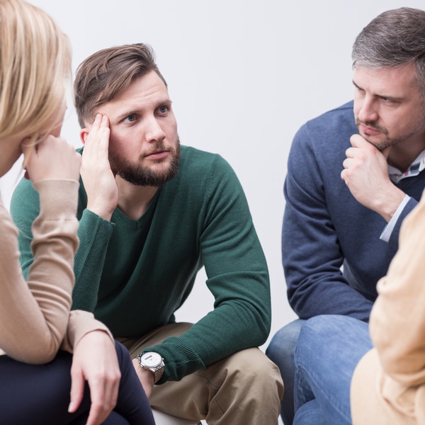 Four people listening in group setting