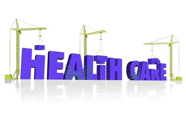 Health care word with construction cranes, symbolizing progress and development in the health care industry