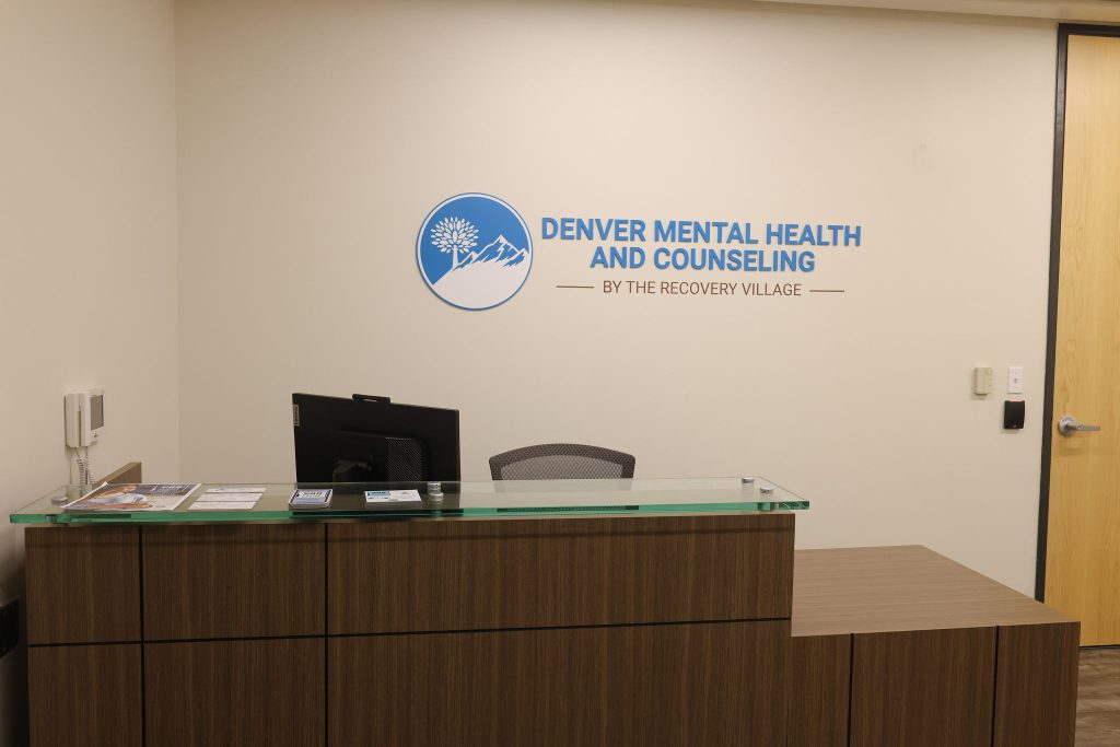 Reception desk at Denver Mental Health and Counseling office with table, chair, and computer