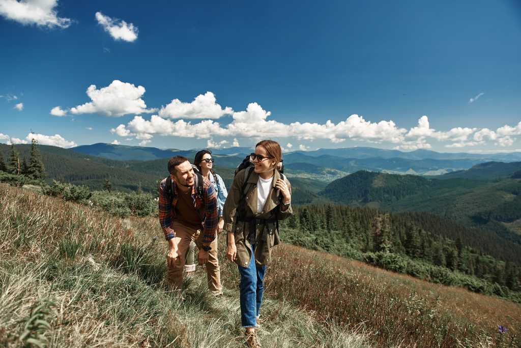 A group of hikers walking along a trail in the mountains